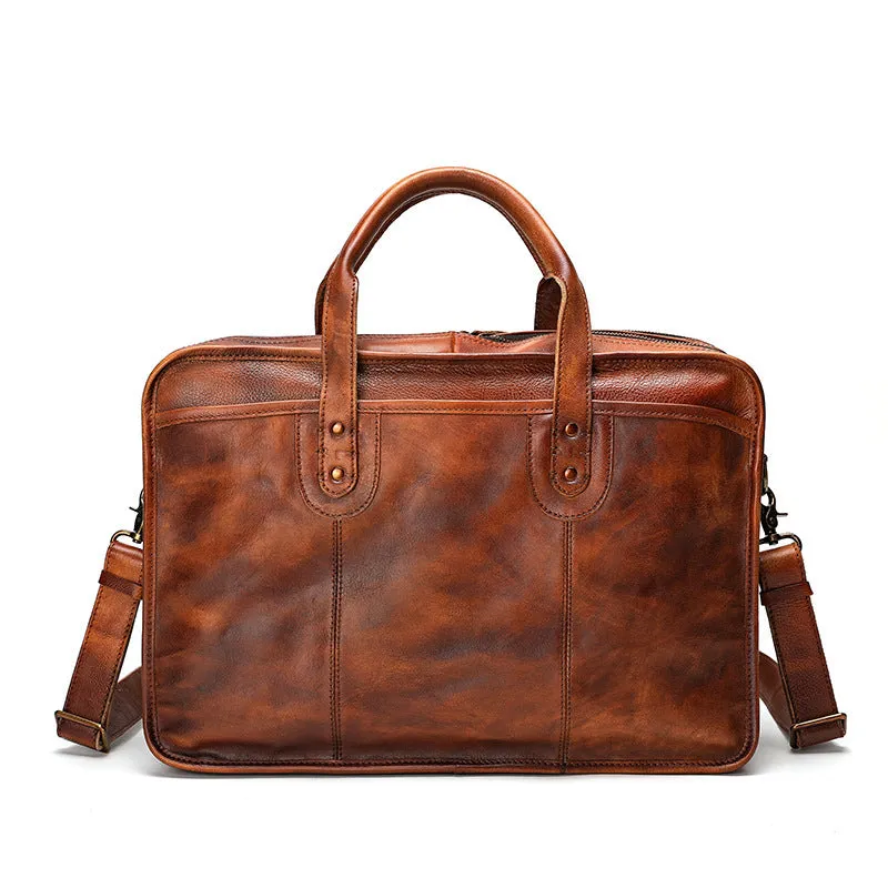 Men's vintage brown leather briefcase open to show internal laptop and camera pockets.