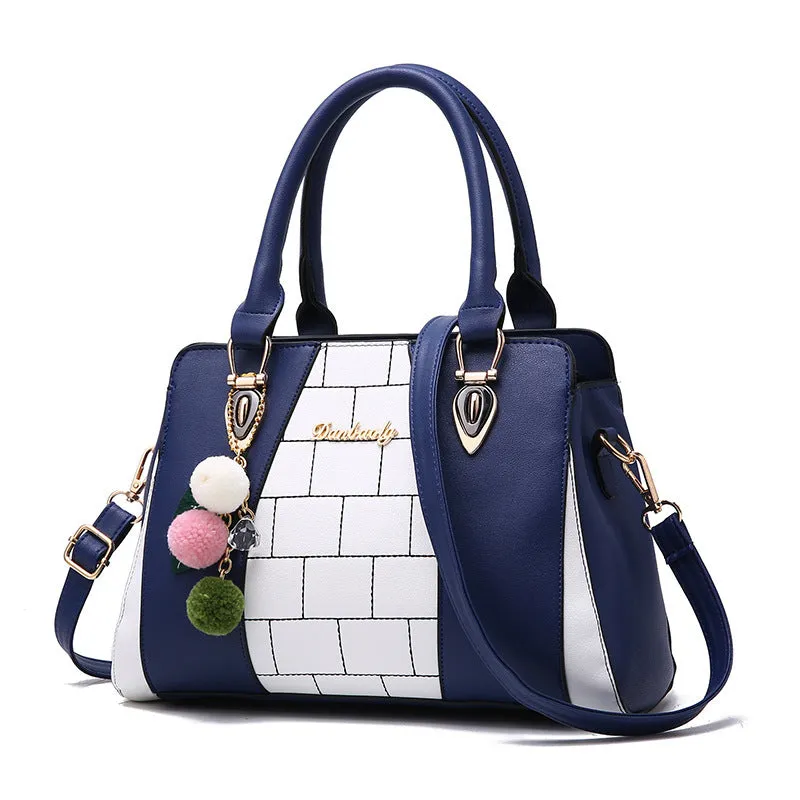 Contrasting colour handbag in PU leather with zipper closure, 29cm long, available in multiple colours