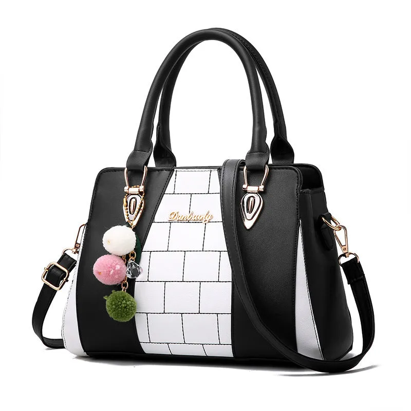 Contrasting colour handbag in PU leather with zipper closure, 29cm long, available in multiple colours