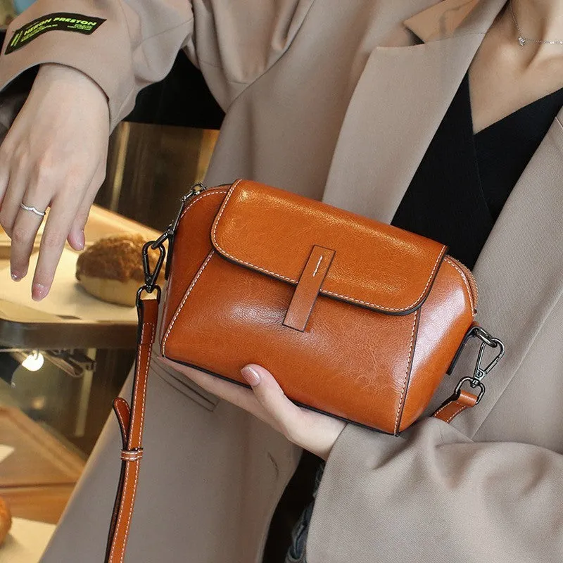 Women's brown oil wax leather messenger bag with crossbody strap and shell shape design