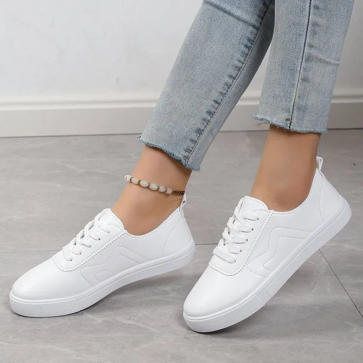 White round toe lace up casual shoes with platform heel on a flat surface