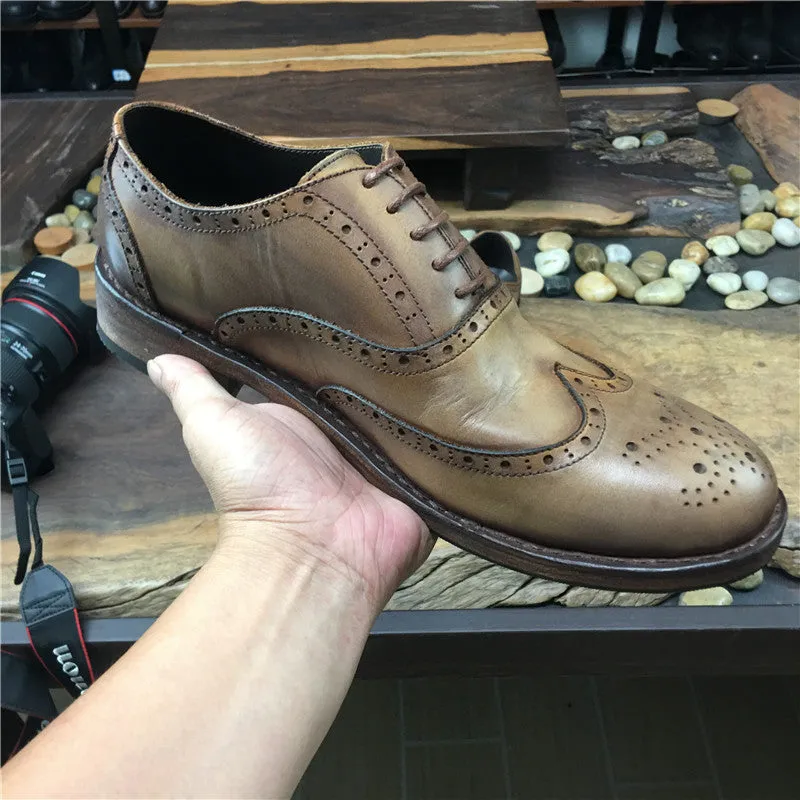 Men's light brown distressed leather lace-up shoes with engraved carving details on the upper.