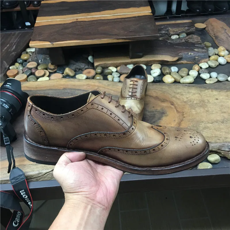 Men's light brown distressed leather lace-up shoes with engraved carving details on the upper.