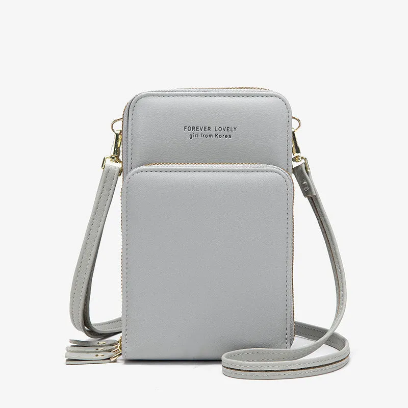 Green crossbody bag with tri-fold pockets and zipper closure on white background