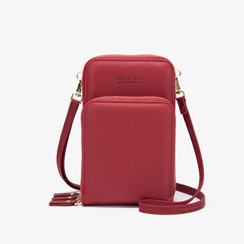 Green crossbody bag with tri-fold pockets and zipper closure on white background