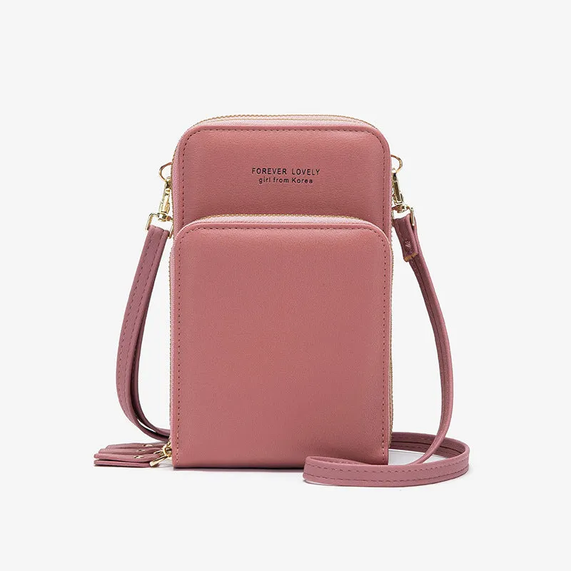 Green crossbody bag with tri-fold pockets and zipper closure on white background
