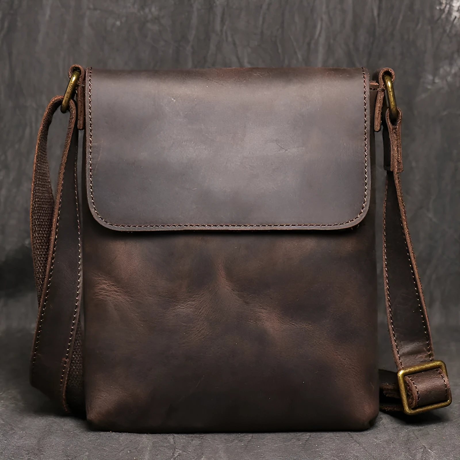 Men's genuine leather messenger bag in retro solid colour black shown on a table