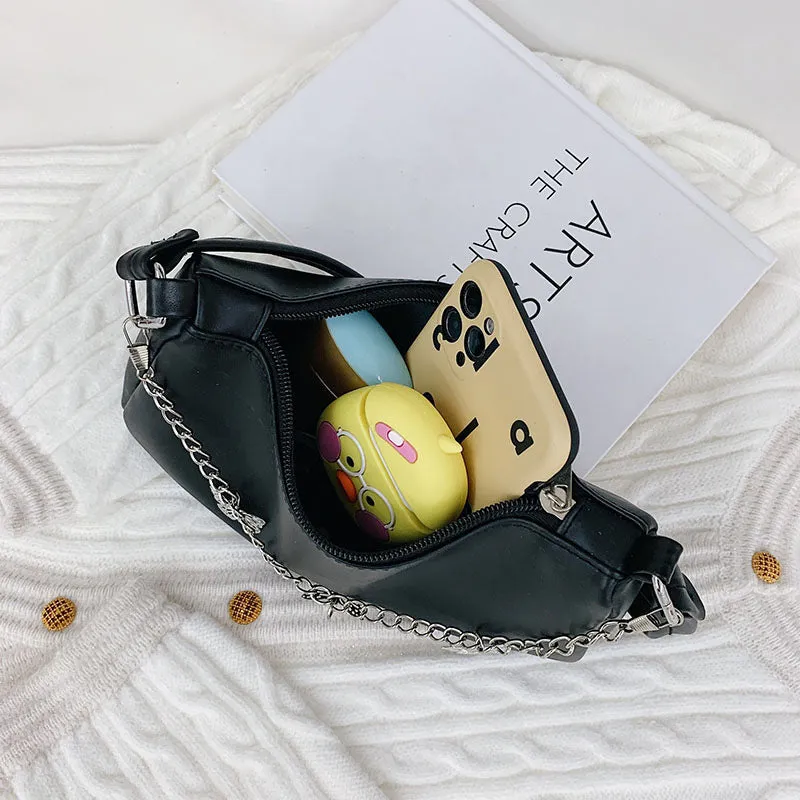Women's black PU leather butterfly chain underarm bag showing crossbody wear with retro styling