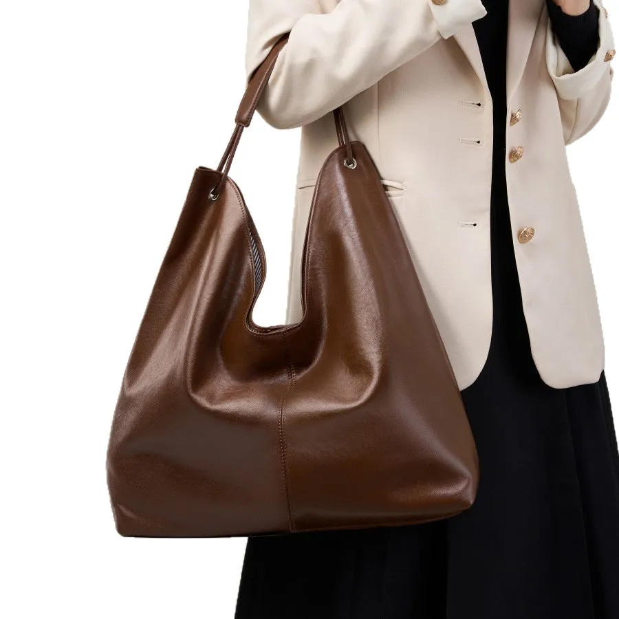 Brown genuine leather tote bag with contrast stitching and large capacity, front view on white background