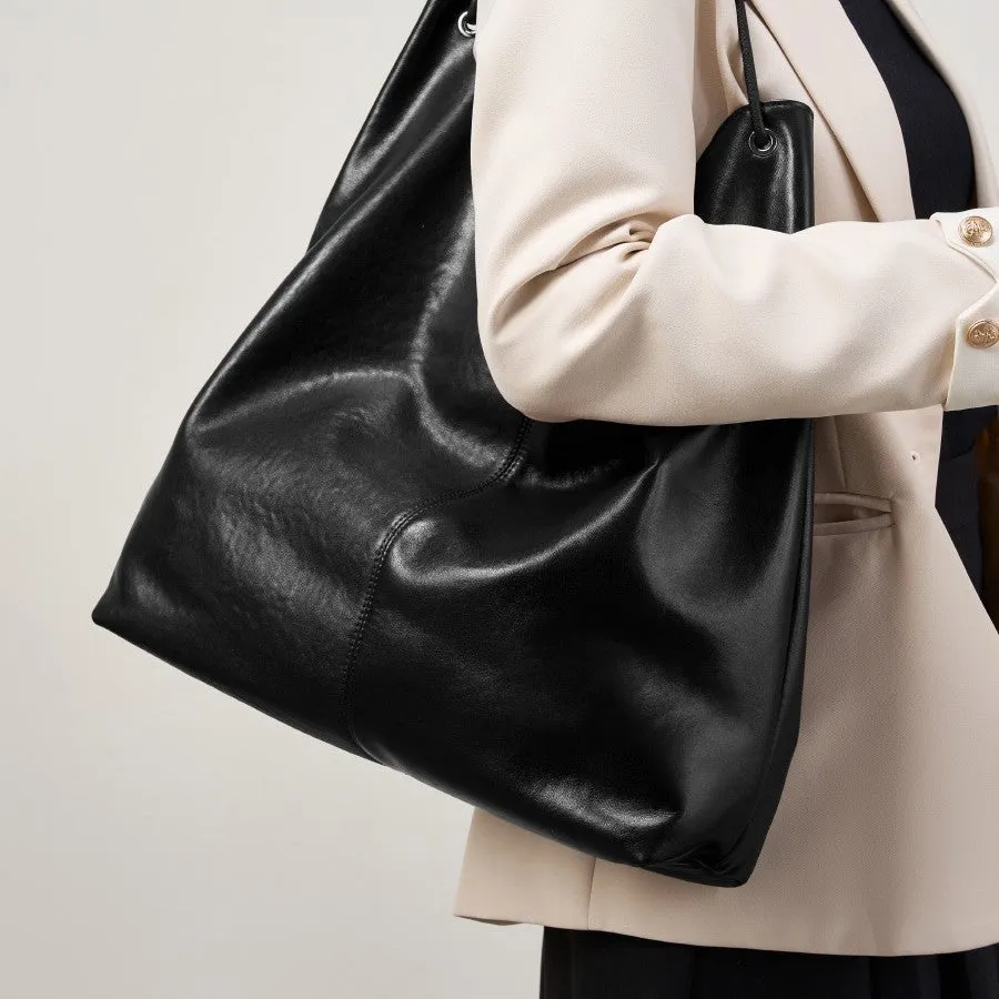 Brown genuine leather tote bag with contrast stitching and large capacity, front view on white background