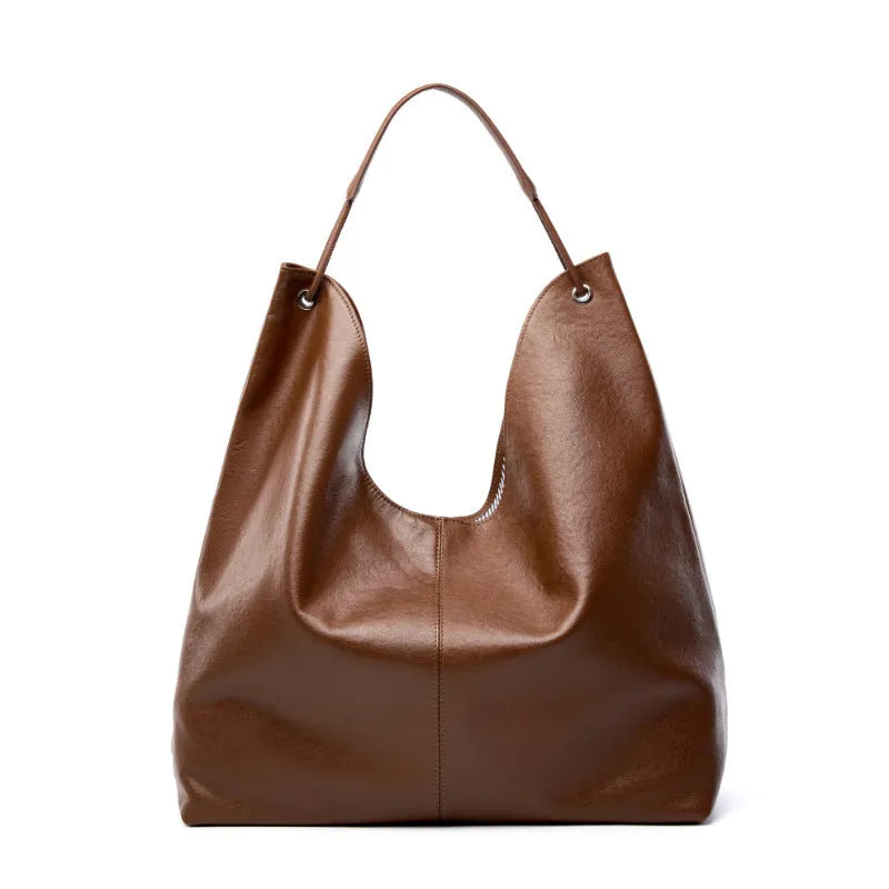 Brown genuine leather tote bag with contrast stitching and large capacity, front view on white background