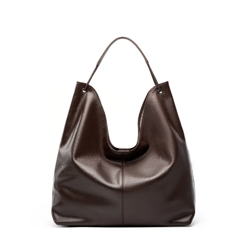Brown genuine leather tote bag with contrast stitching and large capacity, front view on white background