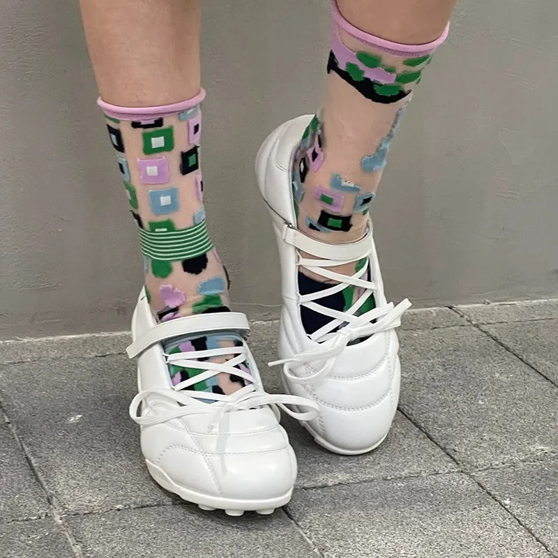 Women's silver low-top sports shoes with lace-up bow and a short stout heel on a viscose sole.