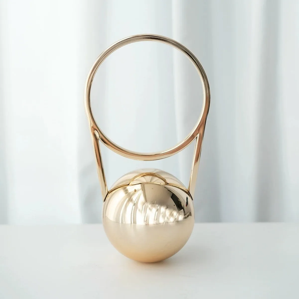 Round hard-shell PVC dinner bag with ball electroplating handle, 25x11x15cm, in silver with stitching detail and slit pocket