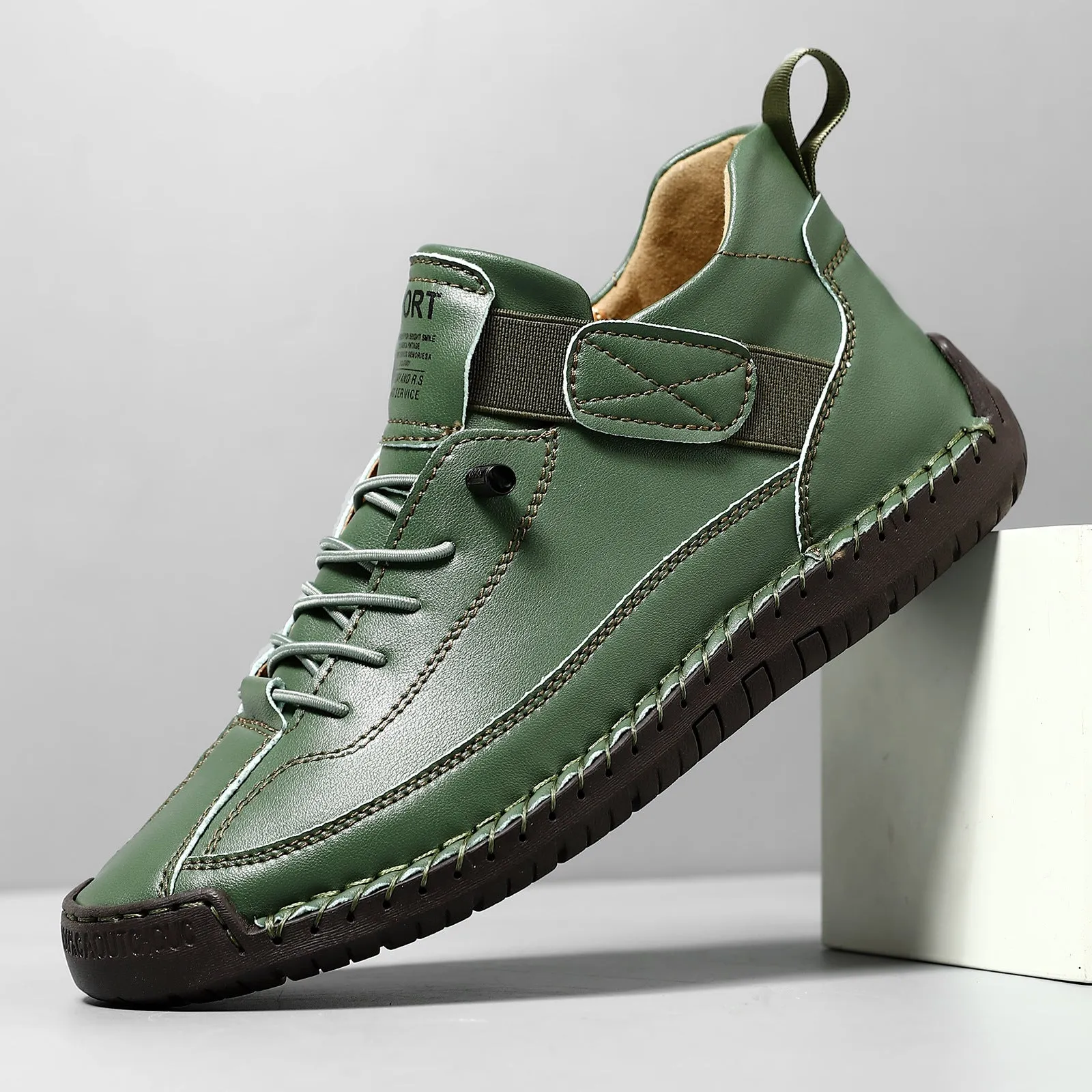Men's mid-calf Martin boots in khaki with visible tooling stitching and an elastic band across the instep.