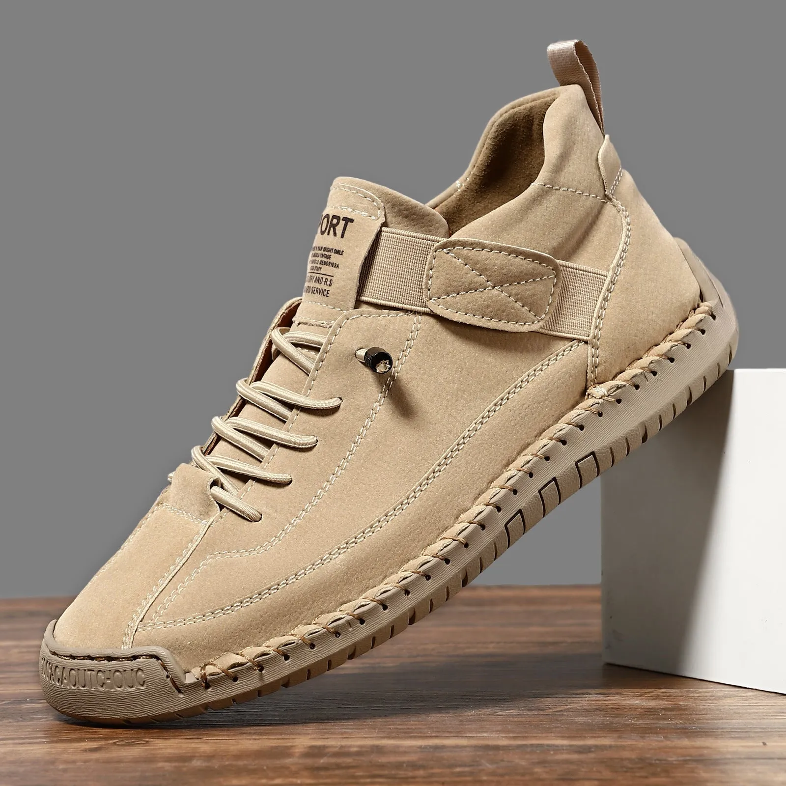 Men's mid-calf Martin boots in khaki with visible tooling stitching and an elastic band across the instep.