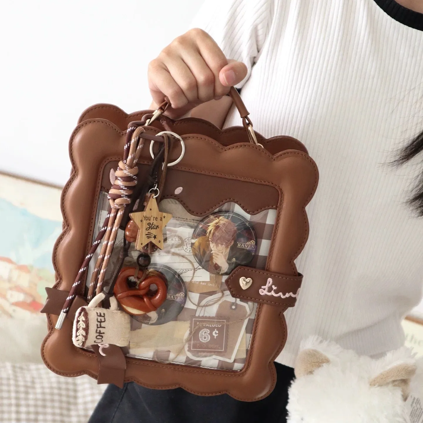 Cross-body PU bag in brown with bow detail, open pocket, and shoulder strap roll