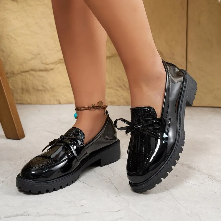 Women's brown and black flat loafers with a bow detail on the artificial PU upper.