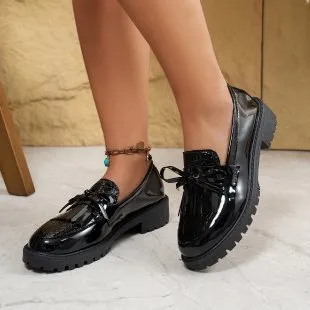 Women's brown and black flat loafers with a bow detail on the artificial PU upper.
