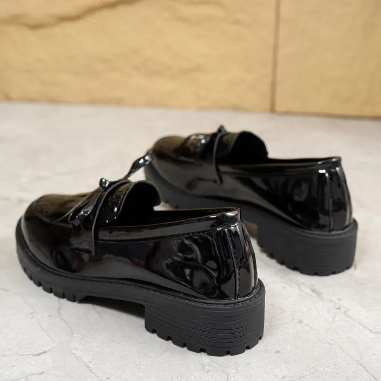Women's brown and black flat loafers with a bow detail on the artificial PU upper.