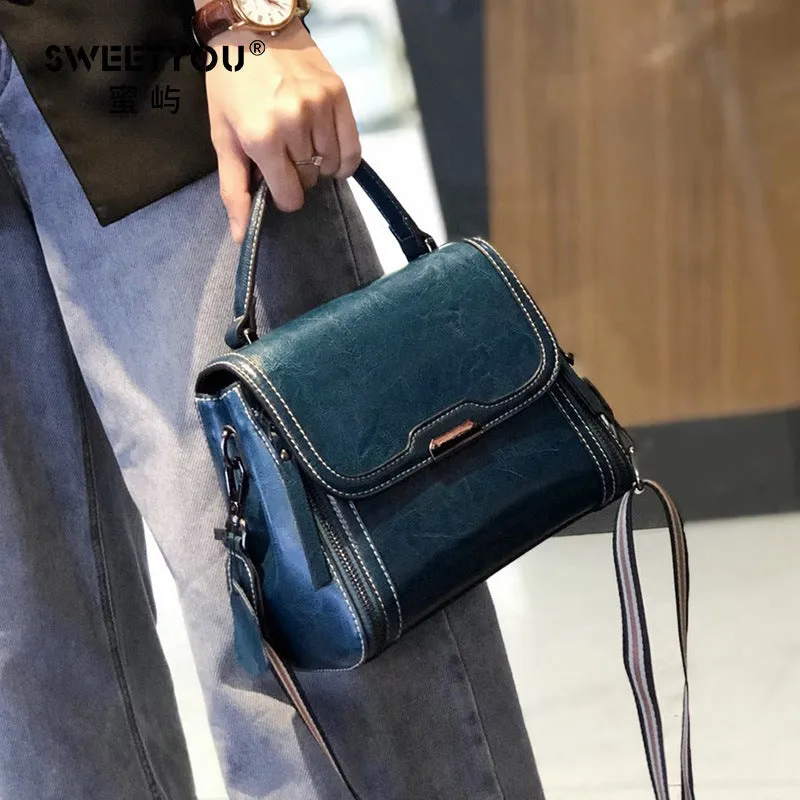 Women's brown genuine oil wax leather messenger bag with double shoulder straps and visible sewing lines