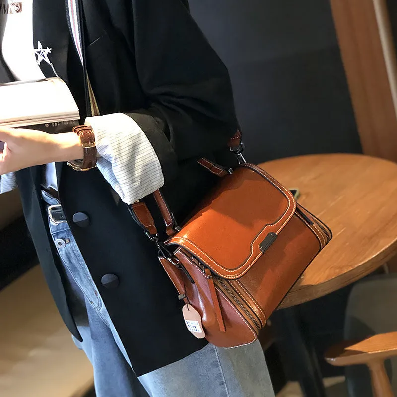 Women's brown genuine oil wax leather messenger bag with double shoulder straps and visible sewing lines