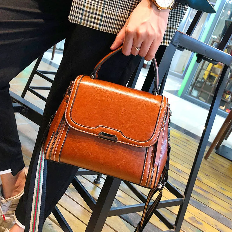 Women's brown genuine oil wax leather messenger bag with double shoulder straps and visible sewing lines