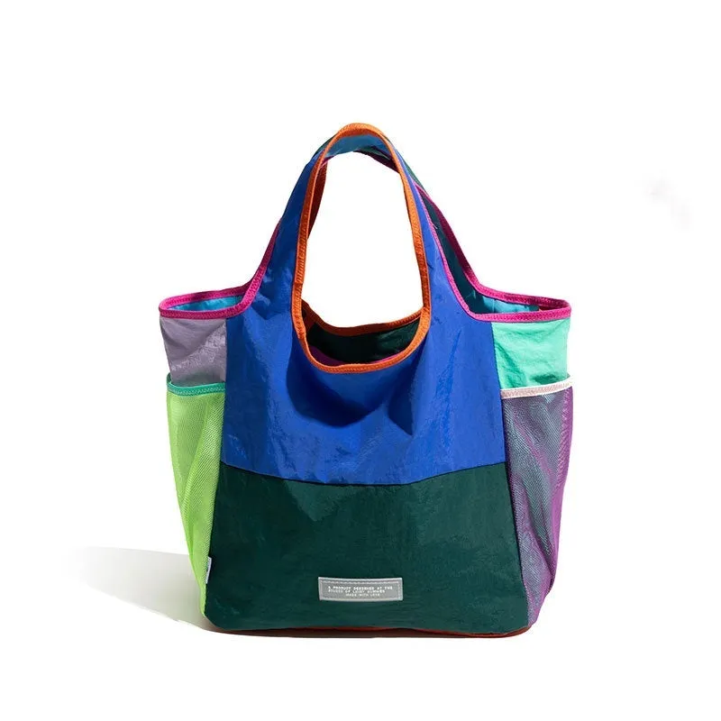 Foldable canvas tote bag in orange with crossbody strap, polyester material