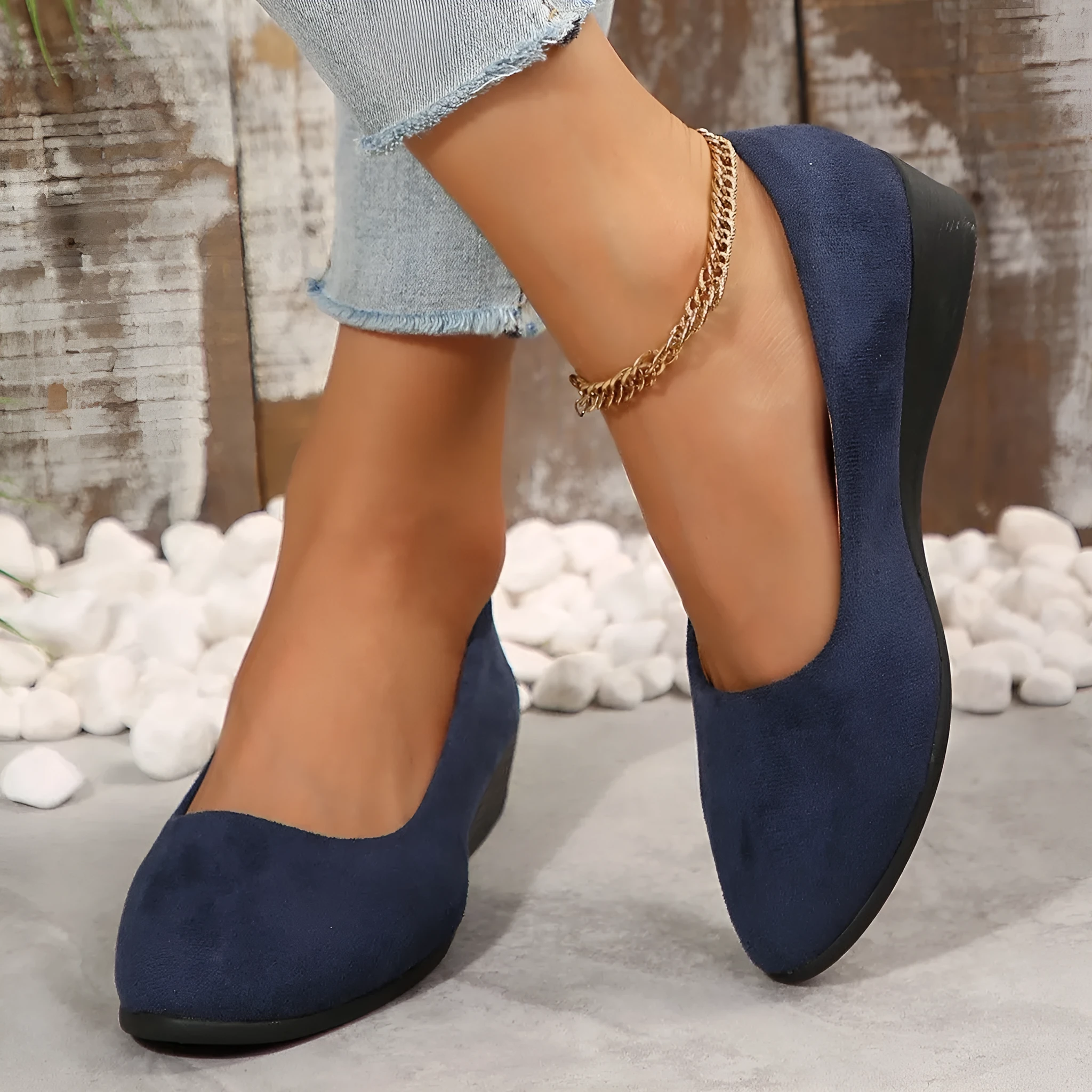 Women's light brown suede wedge pumps with a round toe and shallow mouth design on a rubber sole.