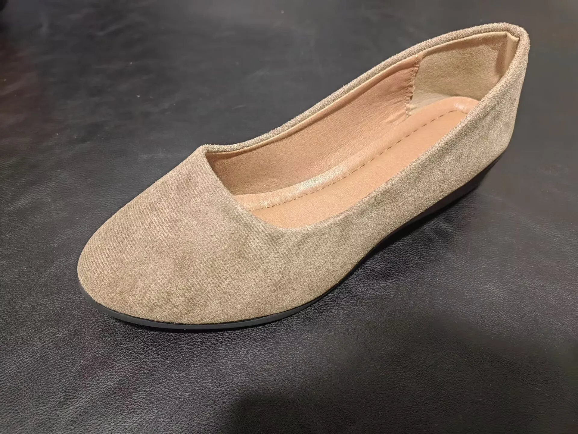 Women's light brown suede wedge pumps with a round toe and shallow mouth design on a rubber sole.