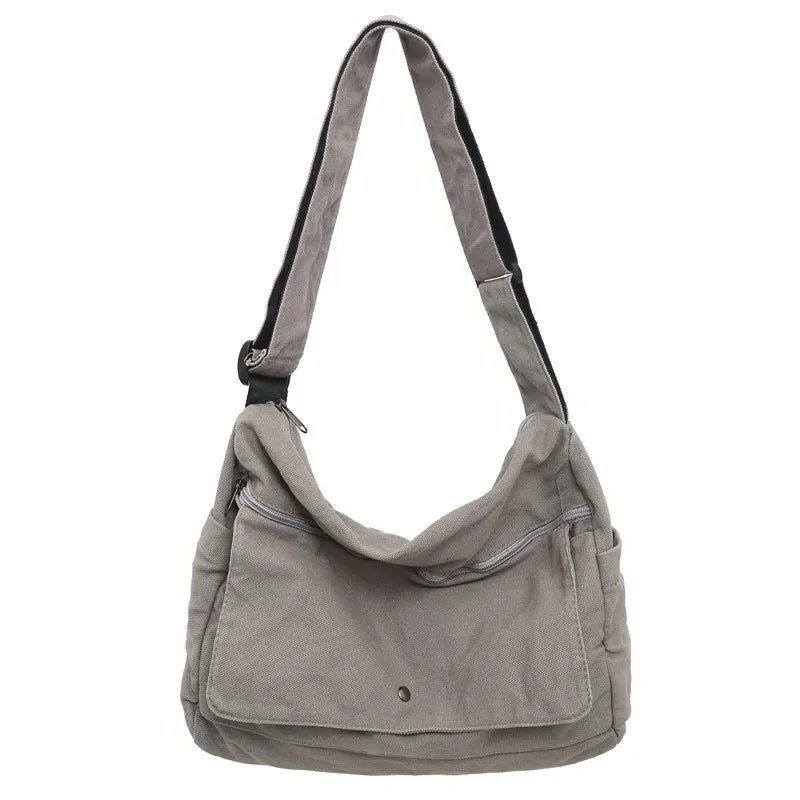 Washed canvas crossbody bag for women in black with single shoulder strap and clamshell shape