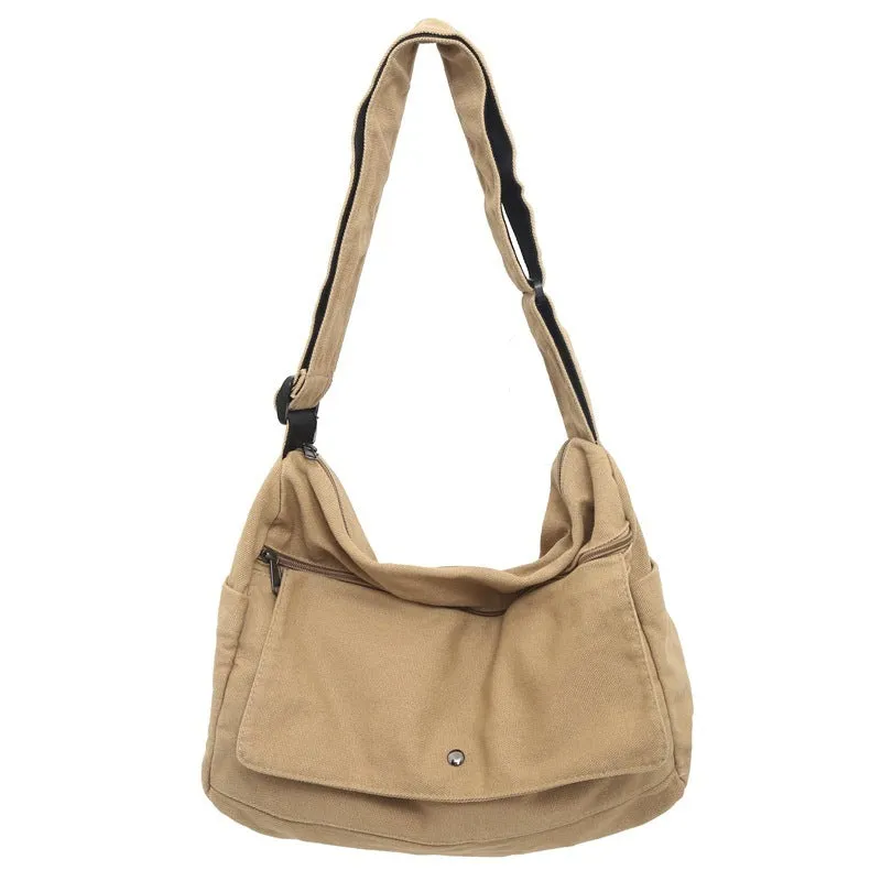 Washed canvas crossbody bag for women in black with single shoulder strap and clamshell shape