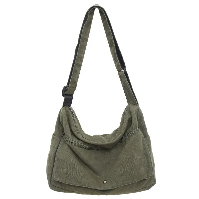 Washed canvas crossbody bag for women in black with single shoulder strap and clamshell shape
