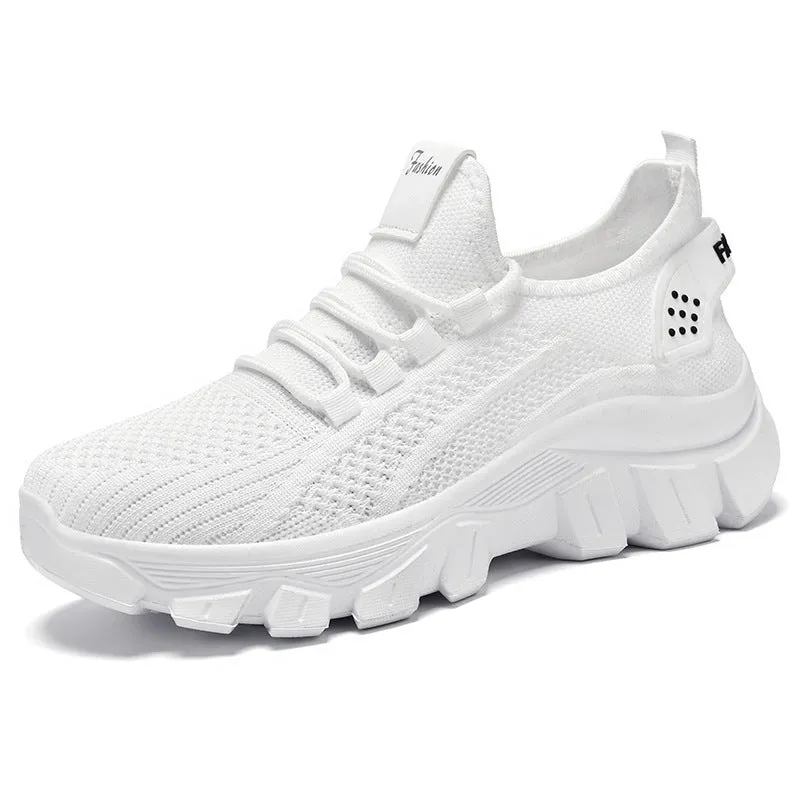 Women's white Flyknit sneakers with thick PVC sole and lace-up front on a neutral background.