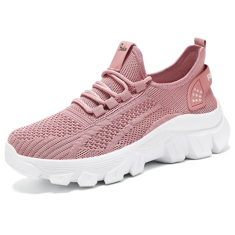 Women's white Flyknit sneakers with thick PVC sole and lace-up front on a neutral background.