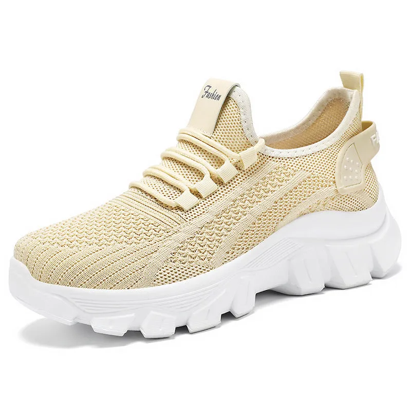 Women's white Flyknit sneakers with thick PVC sole and lace-up front on a neutral background.