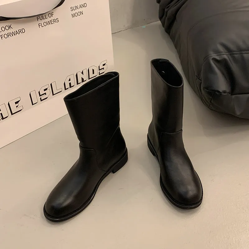 Women's black leather mid-calf platform boots with silver stud details on a white background