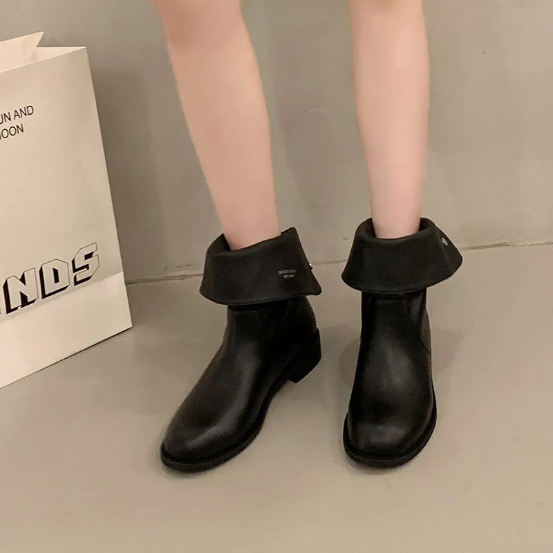 Women's black leather mid-calf platform boots with silver stud details on a white background
