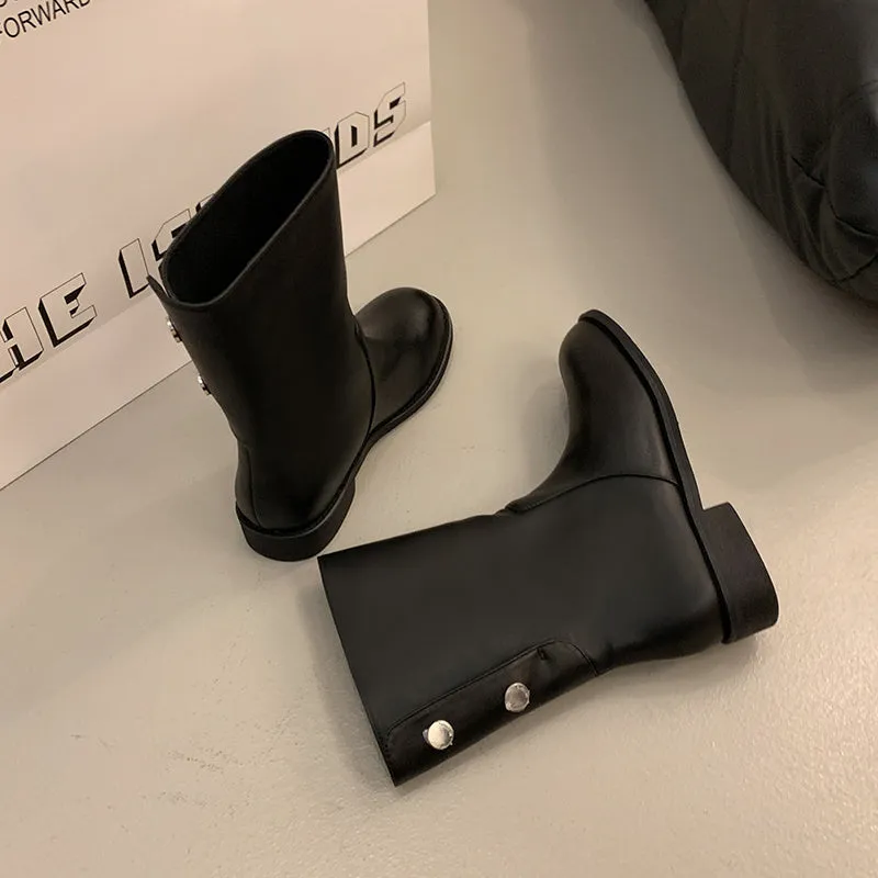 Women's black leather mid-calf platform boots with silver stud details on a white background