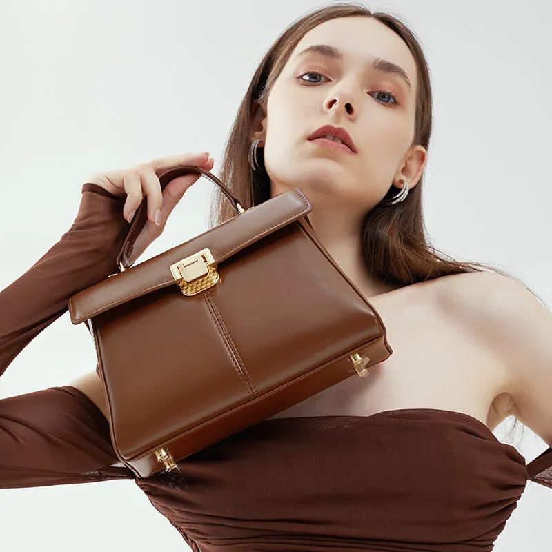 Black genuine leather women's shoulder bag with clasp closure and adjustable strap.