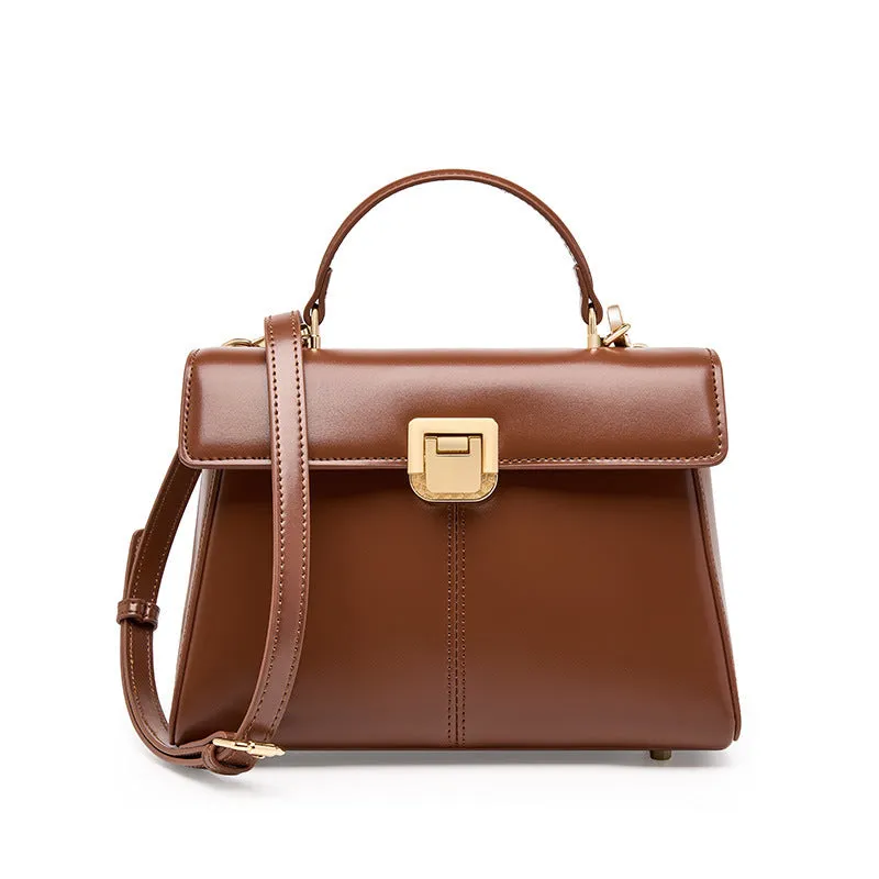 Black genuine leather women's shoulder bag with clasp closure and adjustable strap.
