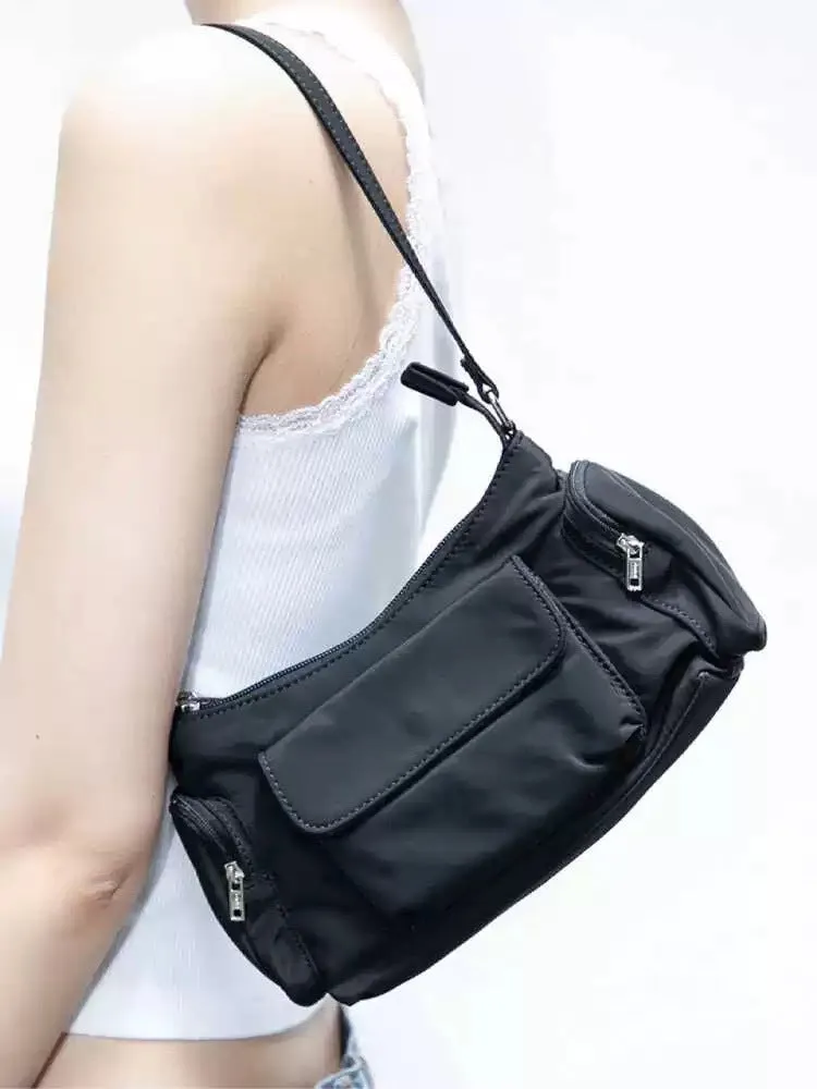 Black nylon lightweight shoulder bag with double pockets showing side line design detail