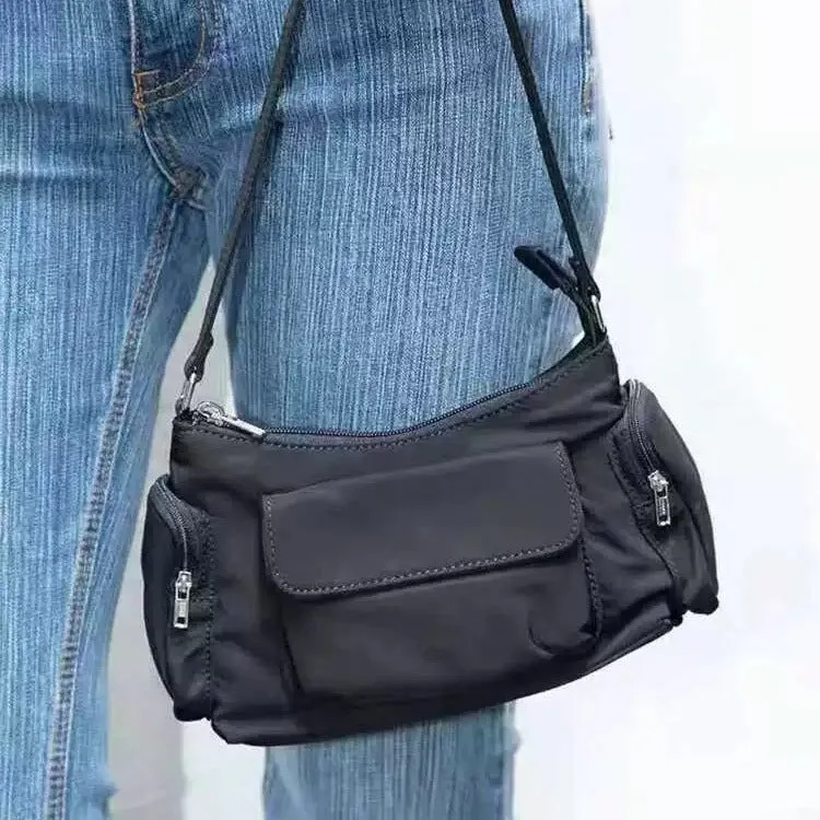 Black nylon lightweight shoulder bag with double pockets showing side line design detail