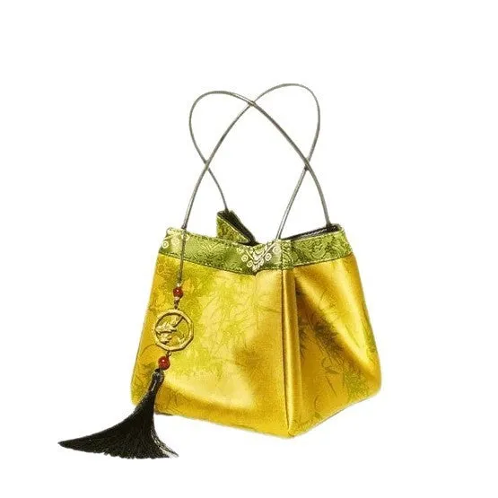 Gold PU leather small square handbag with tassels and sewing line detail on white background