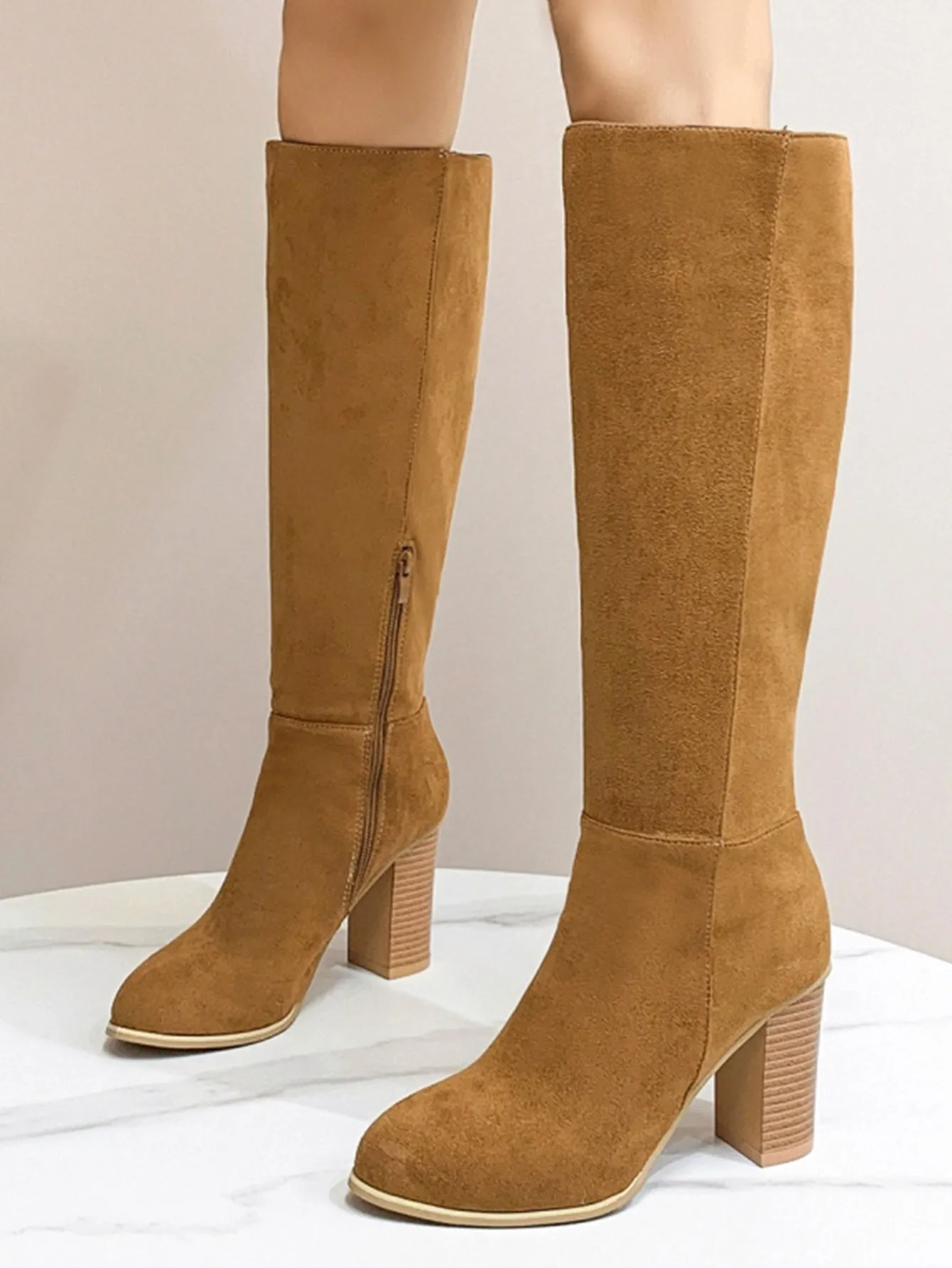 Women's black square toe high heel fashion boot made from artificial PU material.
