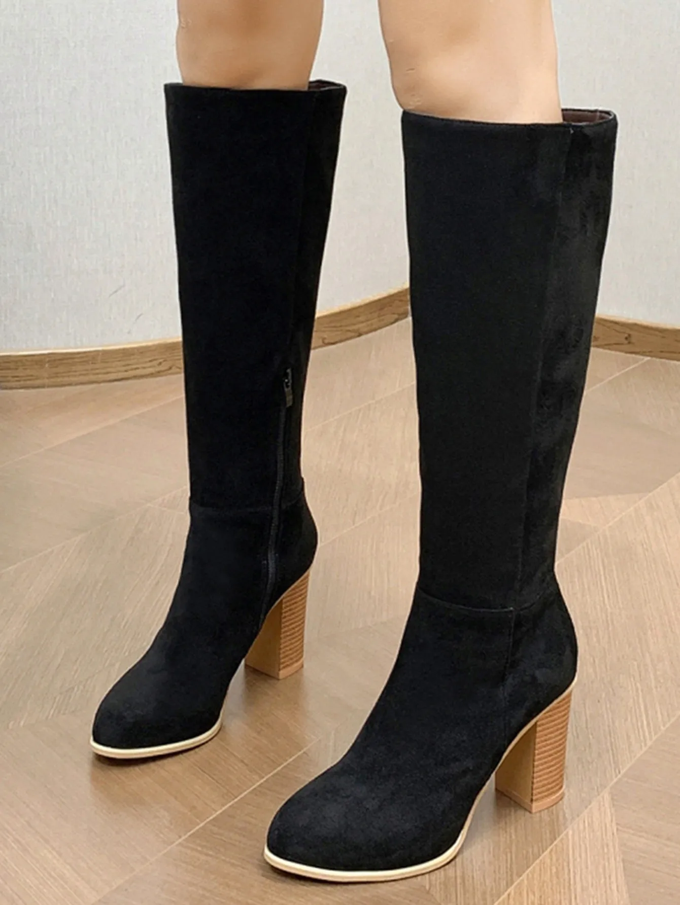 Women's black square toe high heel fashion boot made from artificial PU material.