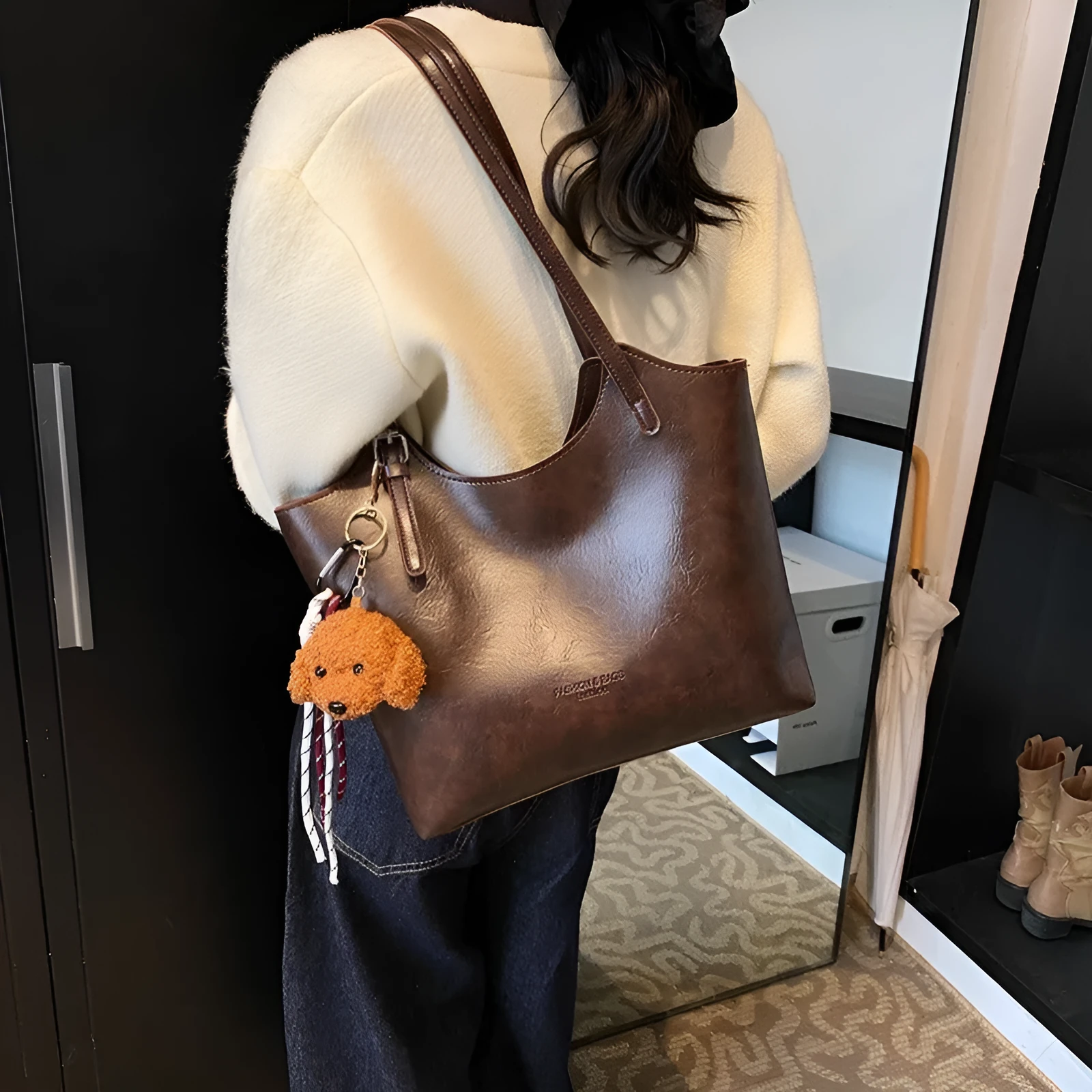Women's PU commuter shoulder bag in black with stitching details and optional ribbon pendant, horizontal square shape