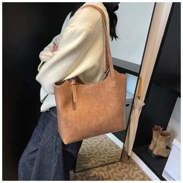 Women's PU commuter shoulder bag in black with stitching details and optional ribbon pendant, horizontal square shape