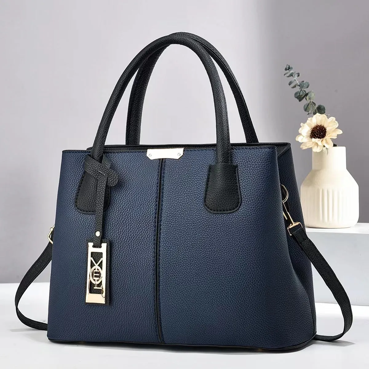 Soft PU leather large capacity shoulder bag for women in a horizontal square shape with an adjustable strap.