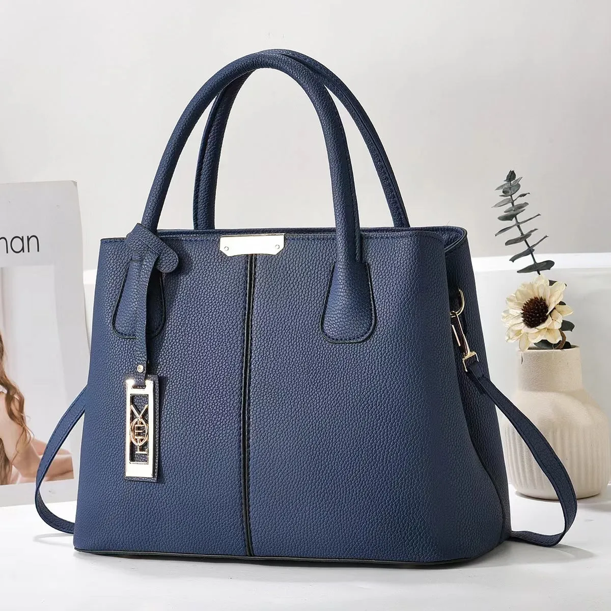 Soft PU leather large capacity shoulder bag for women in a horizontal square shape with an adjustable strap.